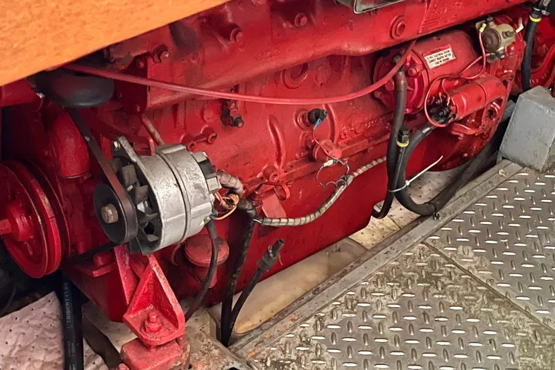 Slide: The Image of Red engine of a 1985 CHB 42 boat, featuring visible components and wiring. - 61