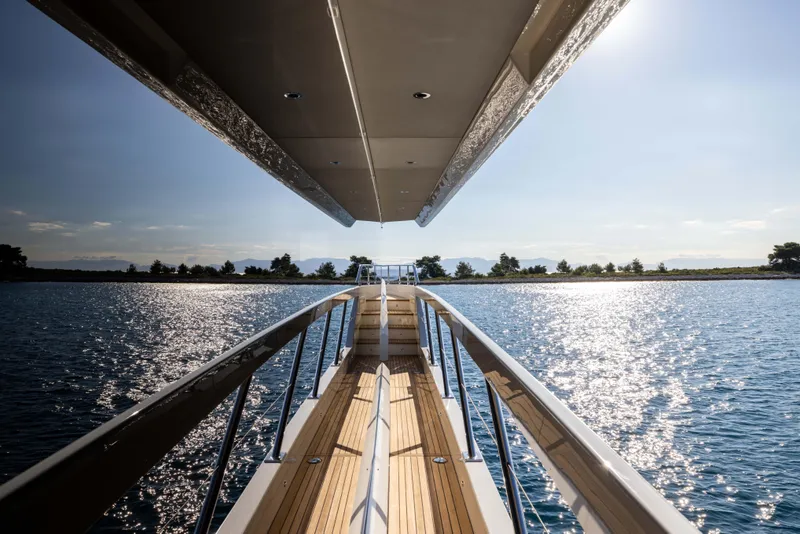 Slide: The Image of 2026 Absolute Navetta Co Ownership yacht on sparkling water, under clear sky. - 38