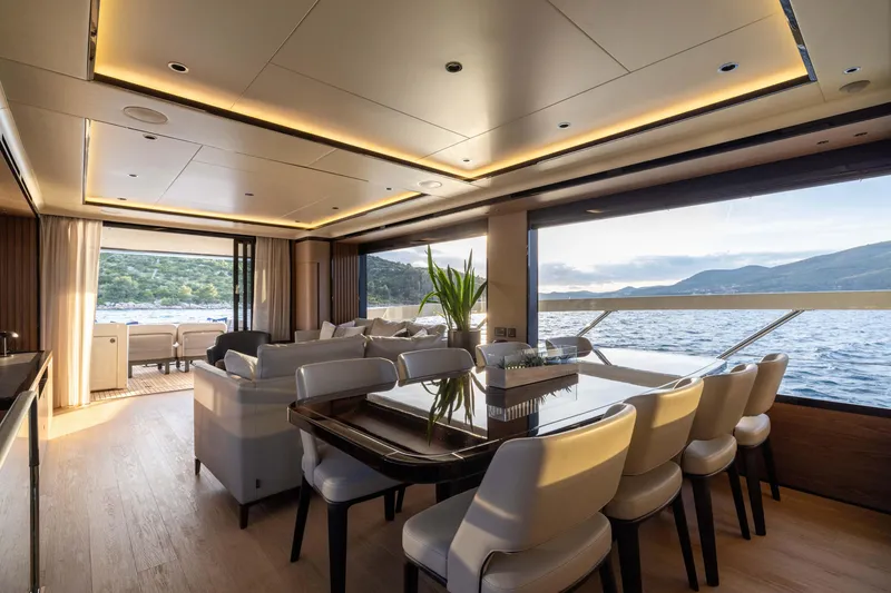 Slide: The Image of Luxurious interior of 2026 Absolute Navetta Co Ownership yacht with dining area and scenic ocean view. - 44