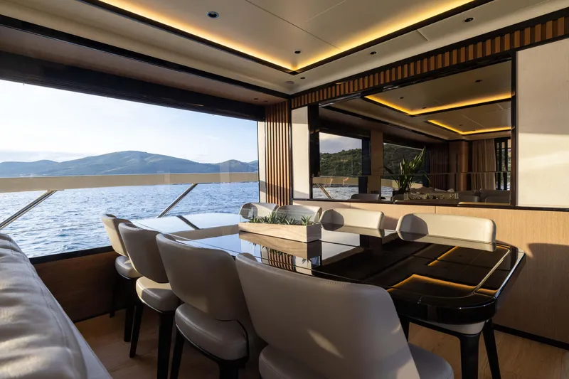 Slide: The Image of Luxurious interior of 2026 Absolute Navetta Co Ownership yacht with elegant dining area and scenic views. - 43