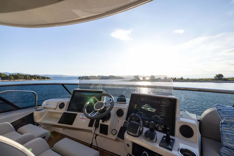 Slide: The Image of Helm of 2026 Absolute Navetta Co Ownership yacht with ocean view at sunset. - 29