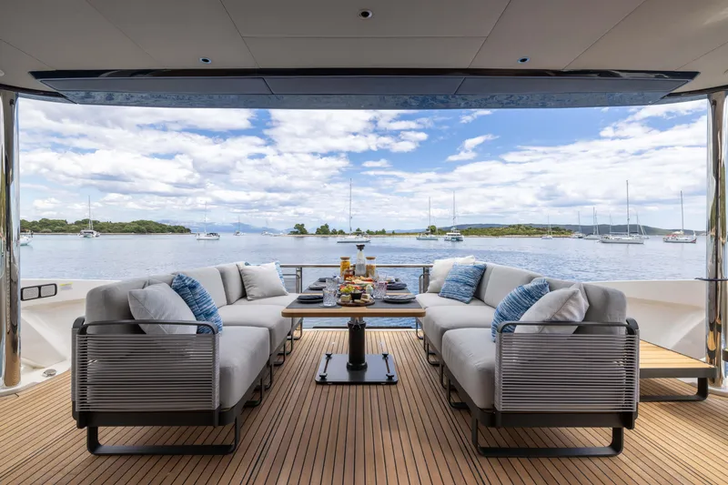 Slide: The Image of Luxurious 2026 Absolute Navetta yacht deck with elegant seating, ocean view, and dining setup. - 21