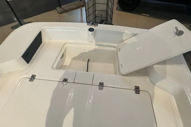 Slide: The Image of 2027 Mako Pro Skiff 15 CC boat interior with open storage compartment. - 10