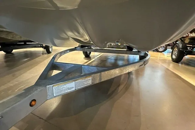 Slide: The Image of 2027 Mako Pro Skiff 15 CC boat on a trailer, showcasing its hull design. - 11
