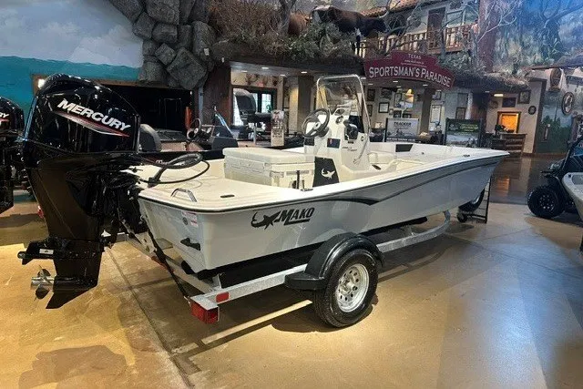 The Image of 2027 Mako Pro Skiff 15 CC boat with Mercury engine on display indoors. - 0