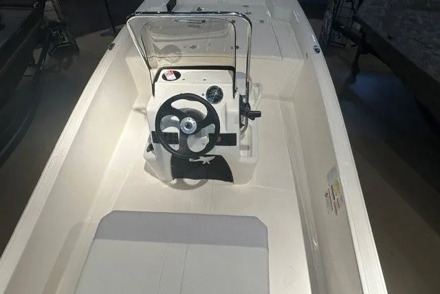 Slide: The Image of 2027 Mako Pro Skiff 15 CC boat interior with steering console and seating. - 7