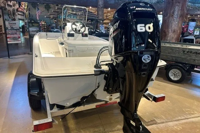 Slide: The Image of 2027 Mako Pro Skiff 15 CC with Mercury 60 engine displayed indoors. - 4