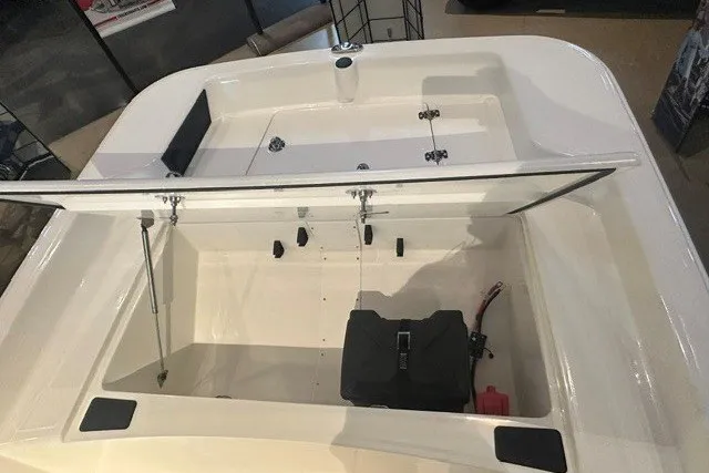 Slide: The Image of 2027 Mako Pro Skiff 15 CC boat interior with open storage compartment. - 9