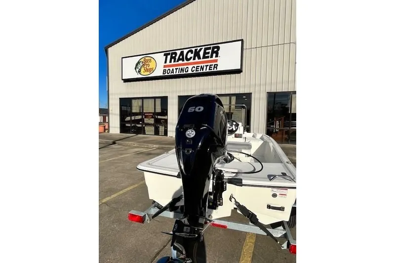 Slide: The Image of 2027 Mako Pro Skiff 15 CC boat at Tracker Boating Center, featuring a 60 HP engine. - 51