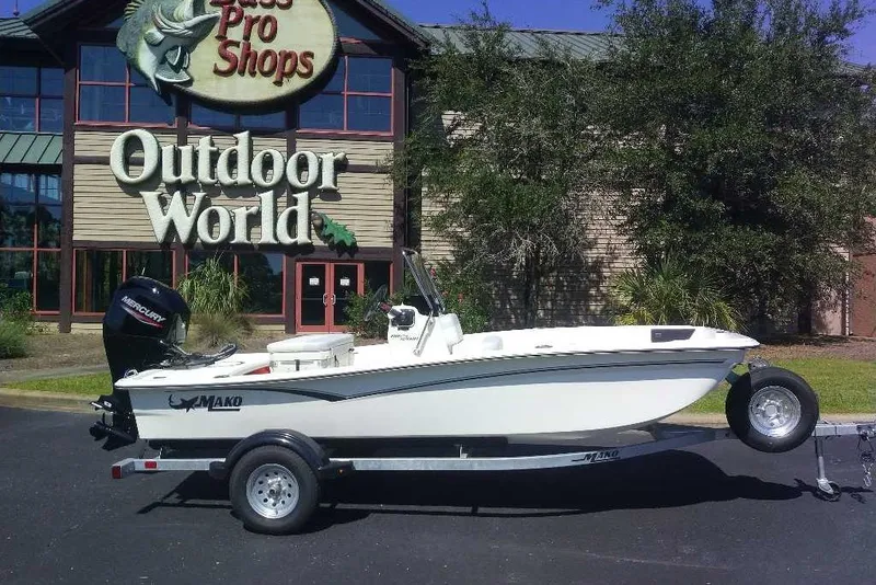 The Image of 2027 Mako Pro Skiff 15 CC boat on trailer outside Bass Pro Shops Outdoor World. - 0