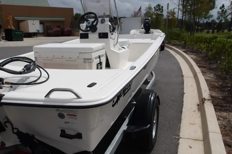 The Image of 2027 Mako Pro Skiff 15 CC boat on trailer, parked outdoors. - 0