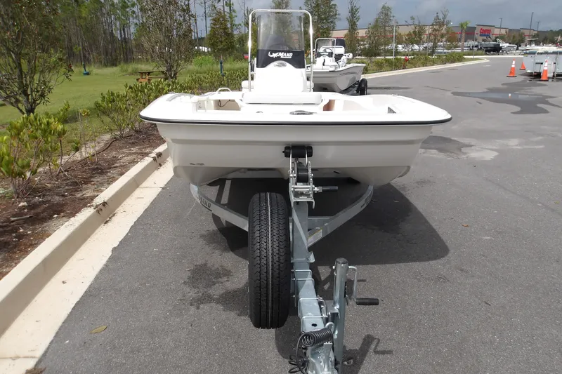 Slide: The Image of 2027 Mako Pro Skiff 15 CC boat on trailer in parking lot. - 7