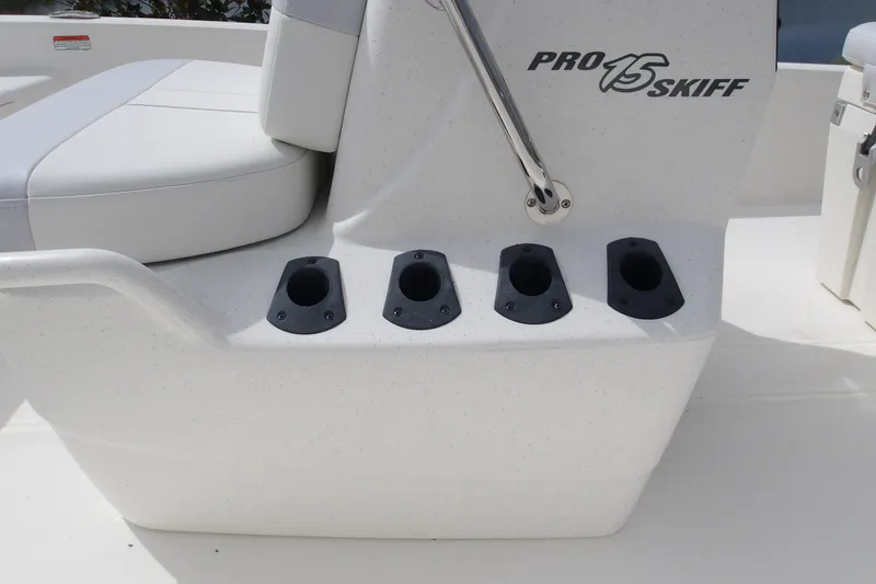 Slide: The Image of 2027 Mako Pro Skiff 15 CC boat console with rod holders and seating. - 9