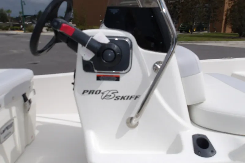 Slide: The Image of 2027 Mako Pro Skiff 15 CC boat console with steering wheel and seating. - 5