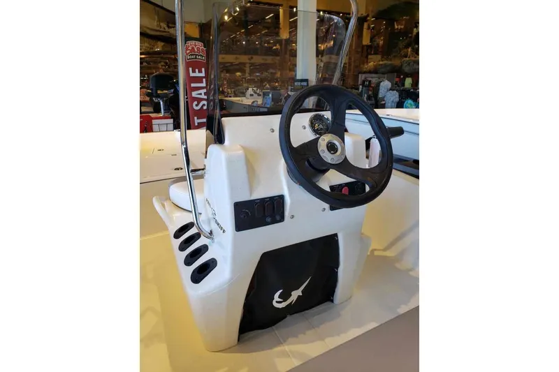 Slide: The Image of 2027 Mako Pro Skiff 15 CC boat console with steering wheel and controls. - 6