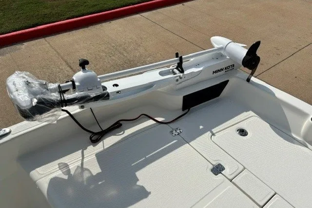 Slide: The Image of 2027 Mako Pro Skiff 15 CC boat with Minn Kota trolling motor on deck. - 5