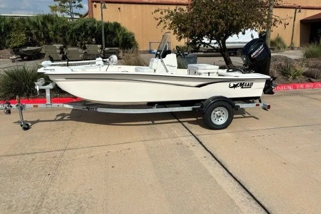 The Image of 2027 Mako Pro Skiff 15 CC boat on trailer, parked outdoors. - 0
