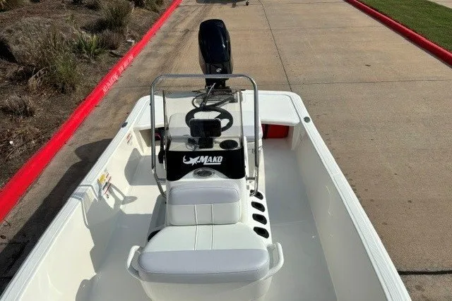 Slide: The Image of 2027 Mako Pro Skiff 15 CC boat with center console and outboard motor. - 4
