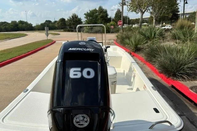 Slide: The Image of 2027 Mako Pro Skiff 15 CC with Mercury 60 engine, parked outdoors. - 9