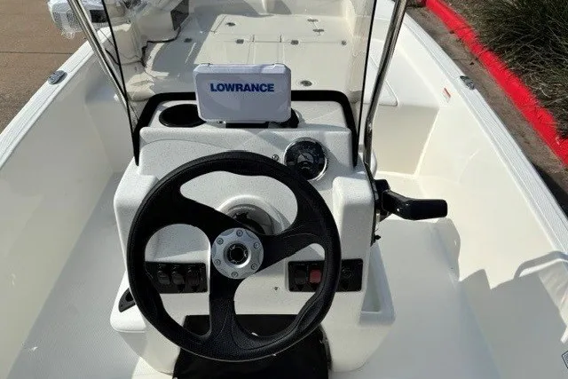 Slide: The Image of 2027 Mako Pro Skiff 15 CC boat console with steering wheel and Lowrance device. - 7