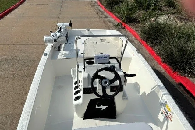 Slide: The Image of 2027 Mako Pro Skiff 15 CC boat with steering console and Lowrance equipment. - 3