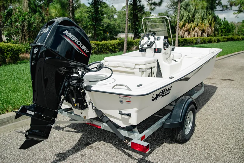Slide: The Image of 2027 Mako Pro Skiff 15 CC boat with Mercury engine on a trailer. - 7