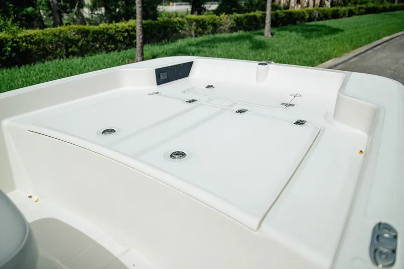 Slide: The Image of 2027 Mako Pro Skiff 15 CC boat deck, featuring sleek design and storage compartments. - 12