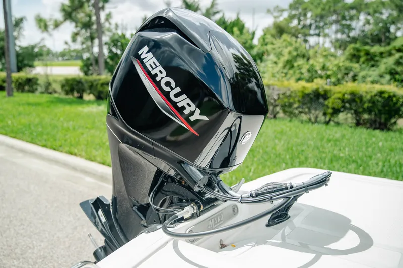 Slide: The Image of 2027 Mako Pro Skiff 15 CC with Mercury outboard motor, parked outdoors. - 8