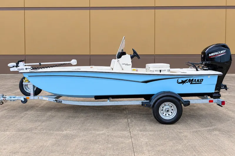 The Image of 2027 Mako Pro Skiff 15 CC boat on trailer, featuring Mercury outboard motor. - 0