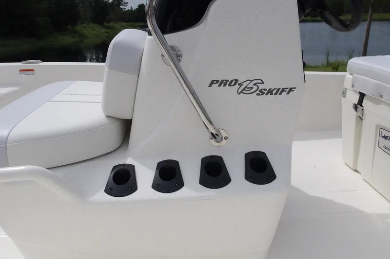 Slide: The Image of 2027 Mako Pro Skiff 15 CC boat interior with rod holders and seating. - 13