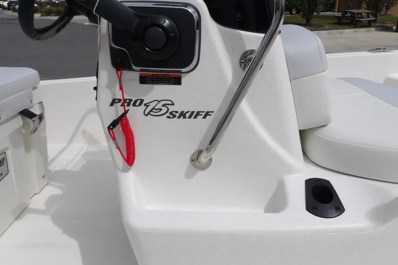 Slide: The Image of 2027 Mako Pro Skiff 15 CC boat console with steering wheel and seating. - 7