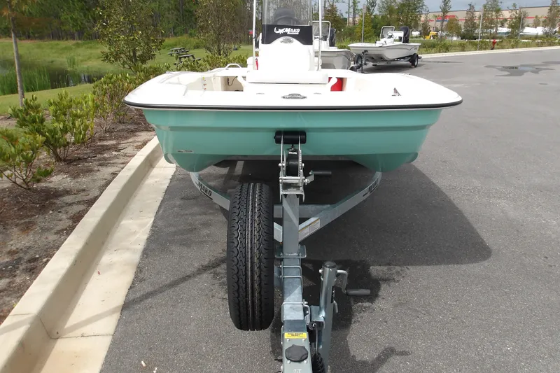 Slide: The Image of 2027 Mako Pro Skiff 15 CC boat on trailer in parking lot. - 8