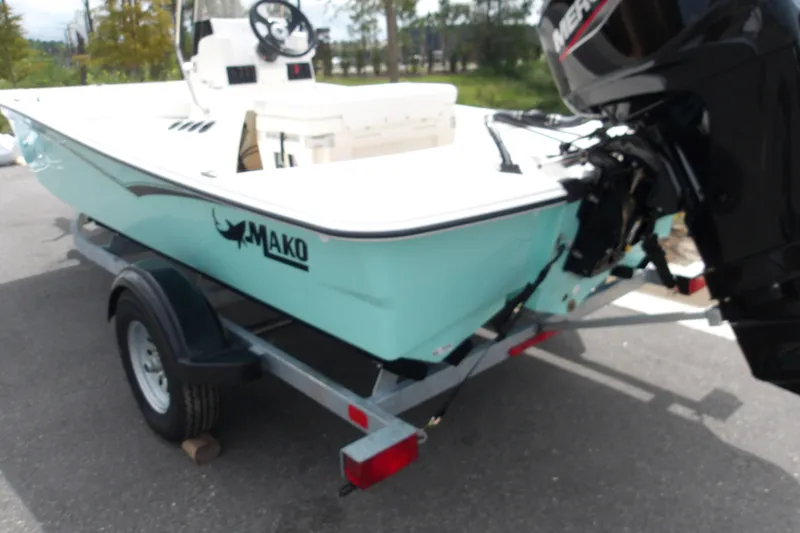 Slide: The Image of 2027 Mako Pro Skiff 15 CC boat on trailer, featuring outboard motor. - 3