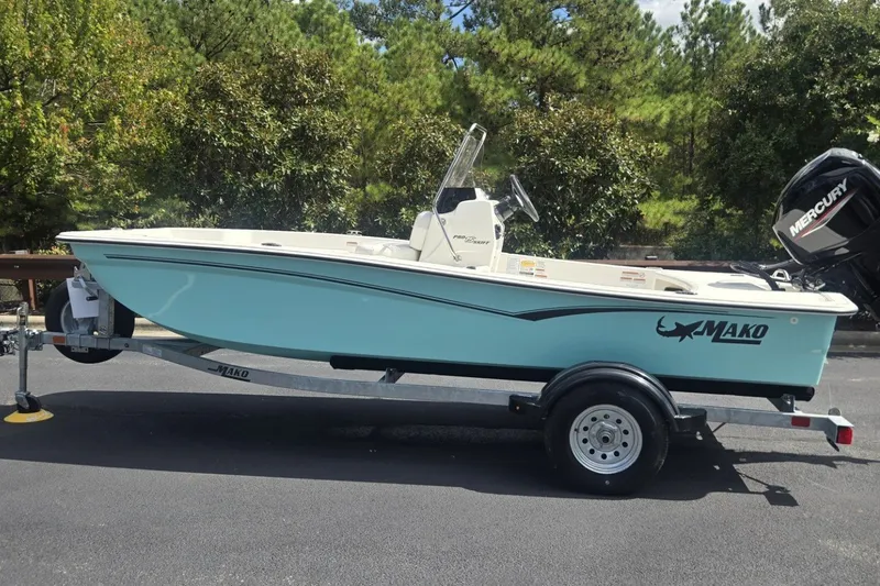 The Image of 2027 Mako Pro Skiff 15 CC boat on trailer, parked outdoors. - 0