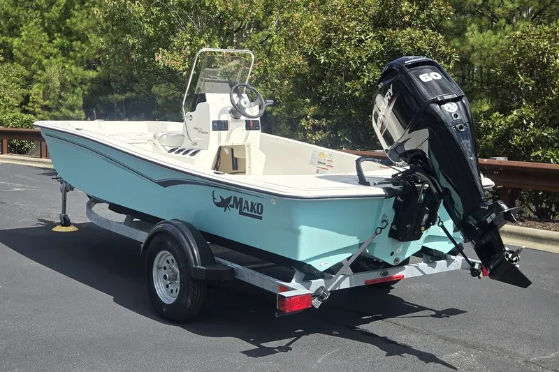 Slide: The Image of 2027 Mako Pro Skiff 15 CC boat on trailer with Mercury outboard motor. - 3