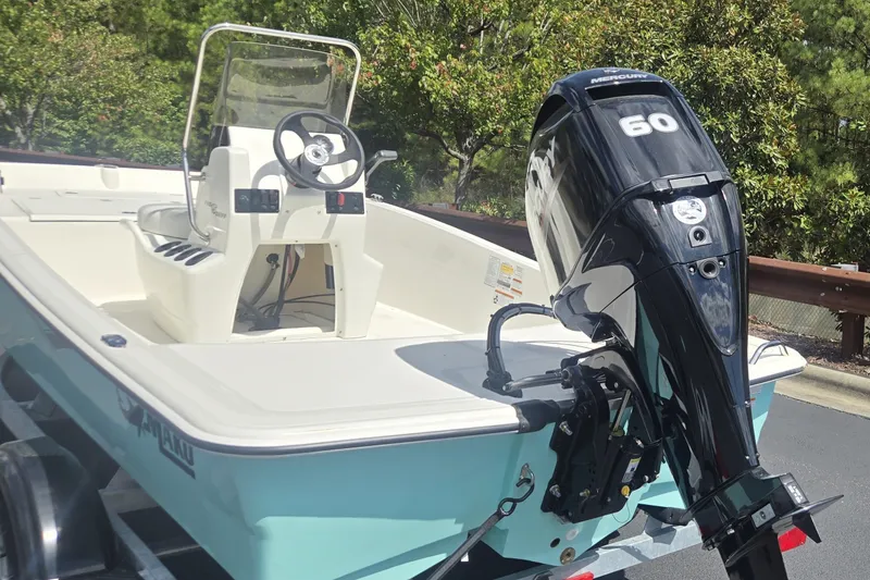 Slide: The Image of 2027 Mako Pro Skiff 15 CC with Mercury 60 engine on trailer. - 2