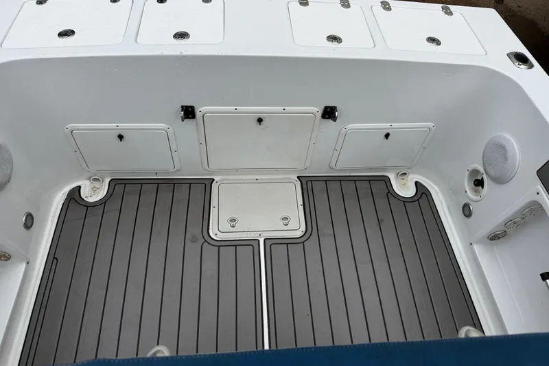 Slide: The Image of 1999 Blue Fin 260 Profish boat deck with storage compartments and non-slip flooring. - 22
