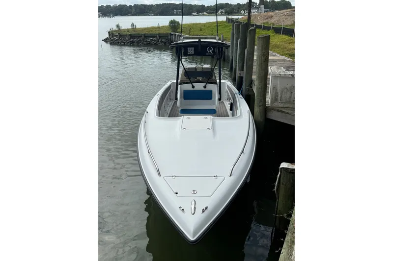 Slide: The Image of 1999 Blue Fin 260 Profish boat docked by the water. - 1