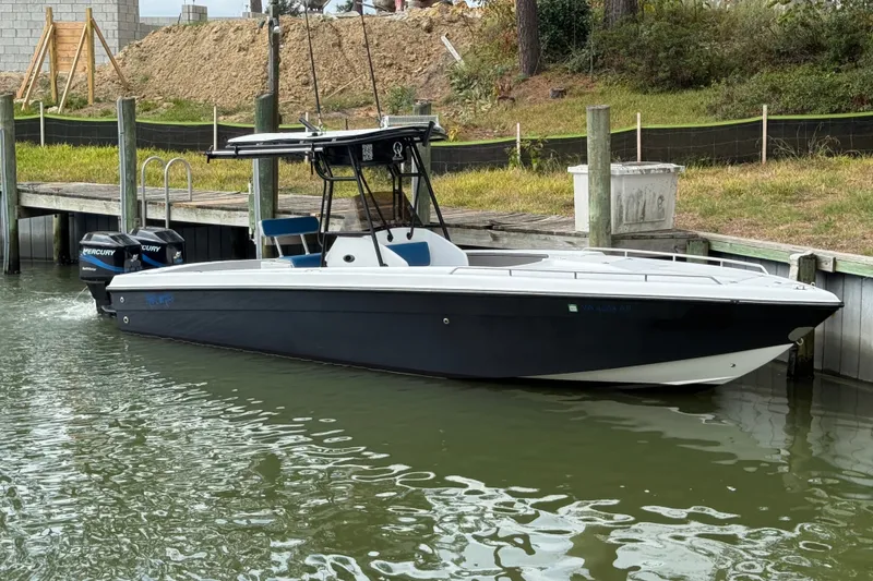 Slide: The Image of 1999 Blue Fin 260 Profish boat docked with dual Mercury engines. - 0