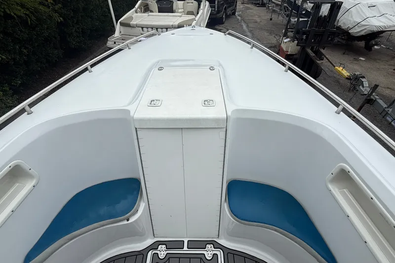Slide: The Image of 1999 Blue Fin 260 Profish boat deck with blue seating and storage compartment. - 12