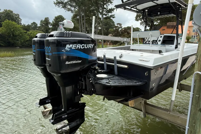 Slide: The Image of 1999 Blue Fin 260 Profish boat with twin Mercury Saltwater engines on a lift. - 5