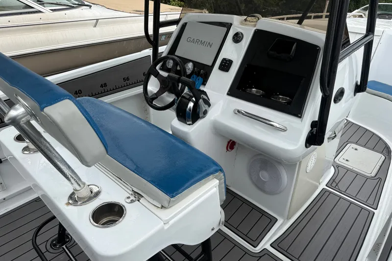 Slide: The Image of 1999 Blue Fin 260 Profish boat cockpit with Garmin navigation system and blue seating. - 23