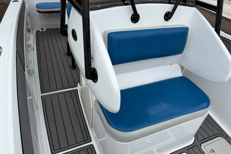 Slide: The Image of Blue Fin 260 Profish 1999 boat interior with blue cushioned seating and gray flooring. - 14