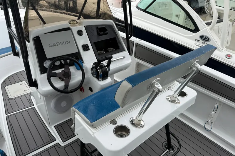 Slide: The Image of 1999 Blue Fin 260 Profish boat cockpit with Garmin navigation system and blue seating. - 20