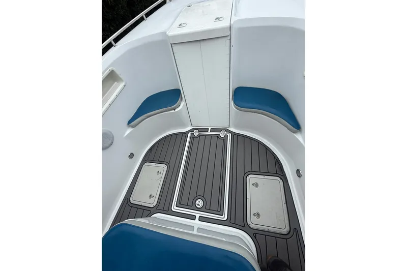 Slide: The Image of 1999 Blue Fin 260 Profish boat interior with blue seating and storage compartments. - 11