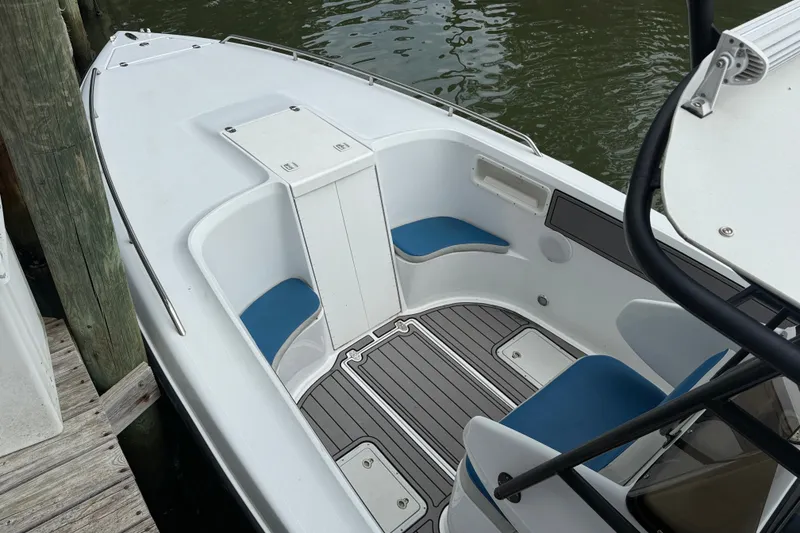 Slide: The Image of 1999 Blue Fin 260 Profish boat interior with blue seating and sleek design. - 7