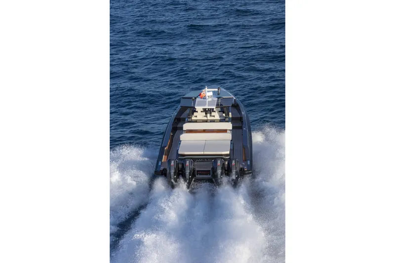 Slide: The Image of The 2026 Wally wallytender48X speeds across the sea, leaving a trail of splashing water. - 8