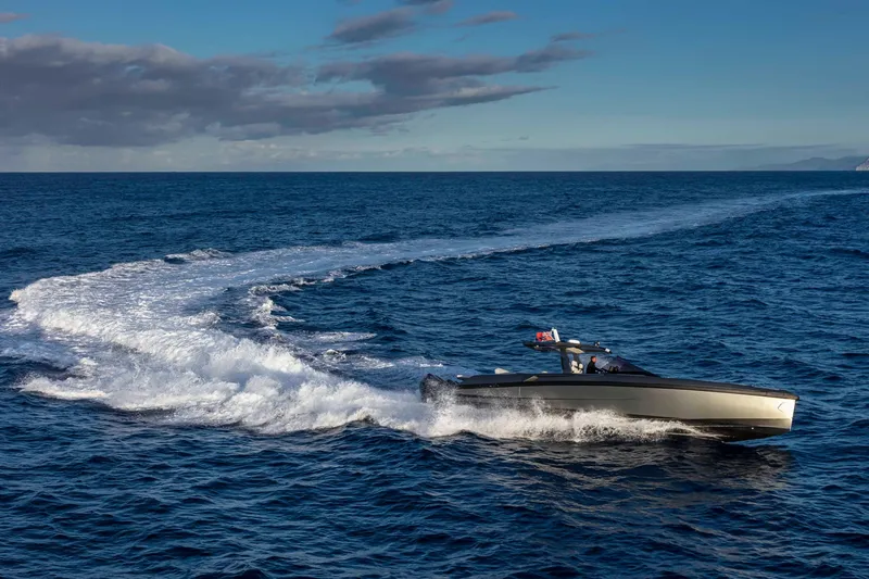 Slide: The Image of A sleek, modern motorboat speeds across the open sea, leaving a white wake behind. - 3