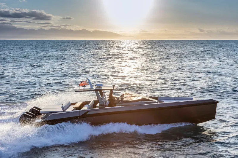 Slide: The Image of A modern motorboat cruising on the sea at sunset. It features a sleek design. - 1