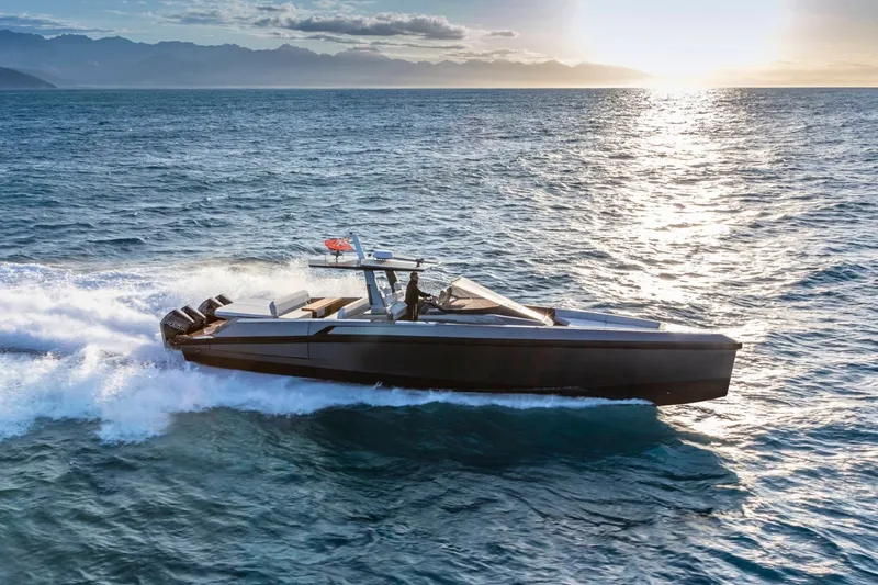 Slide: The Image of A sleek, modern motorboat cruising on the sea at sunset. - 0